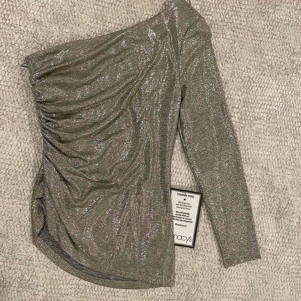 A show-stopping metallic gold one-shoulder long sleeved Adrianna Papell top